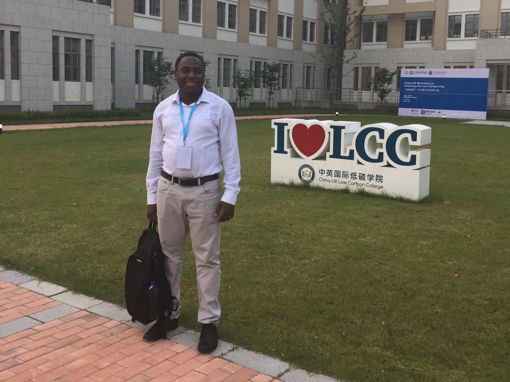 man stood in front of signage and buildings